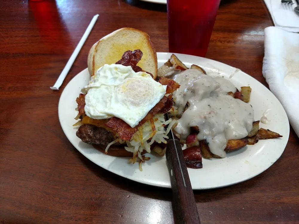 A Hamburger with Eagg Cheese Bacon and Hashbrowns