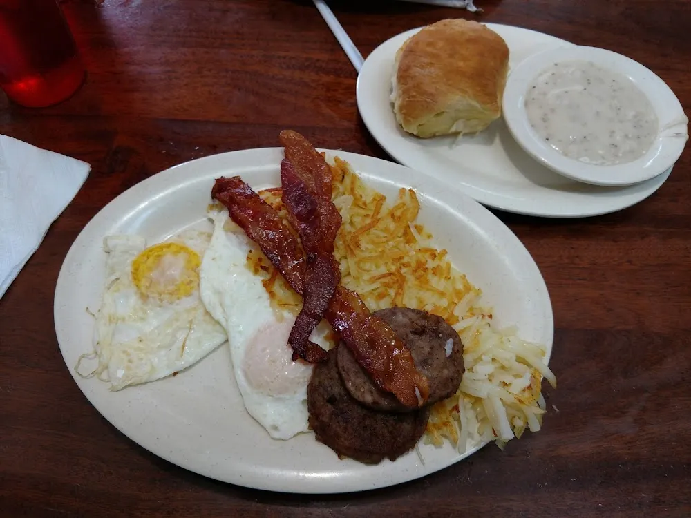 Two Eggs Two Bacon Two Sausage Patties with Hashbrowns and Biscuit with Side of Gravy